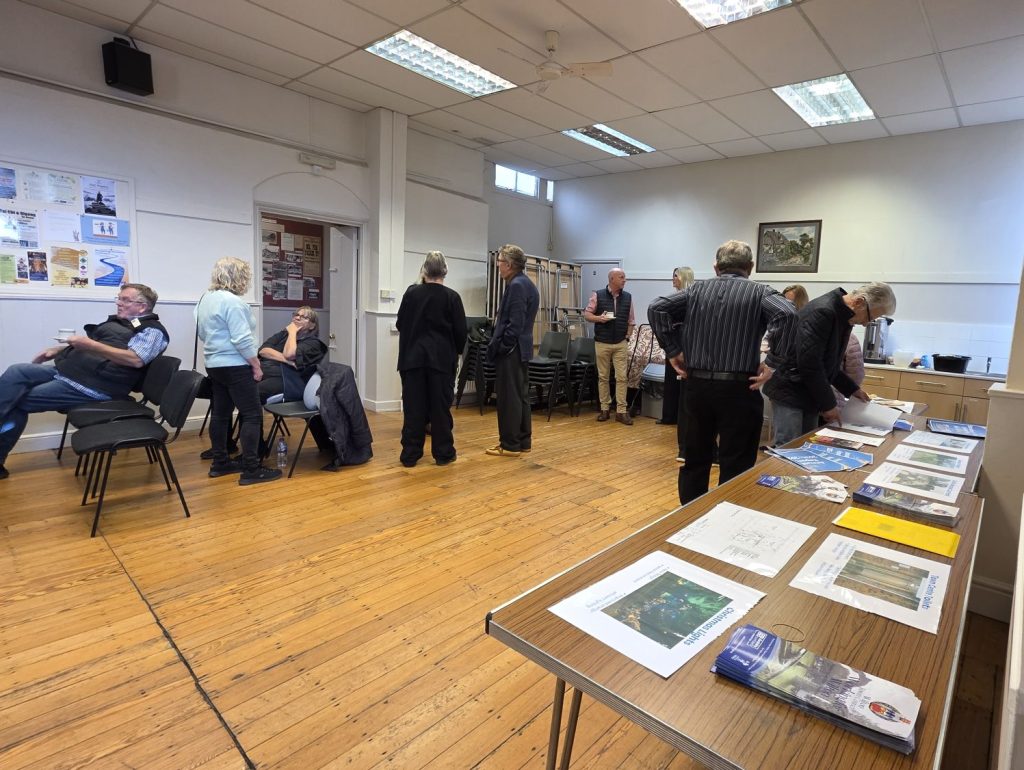 People Gathering at the Annual Town meeting, getting refreshments and browsing the display materials