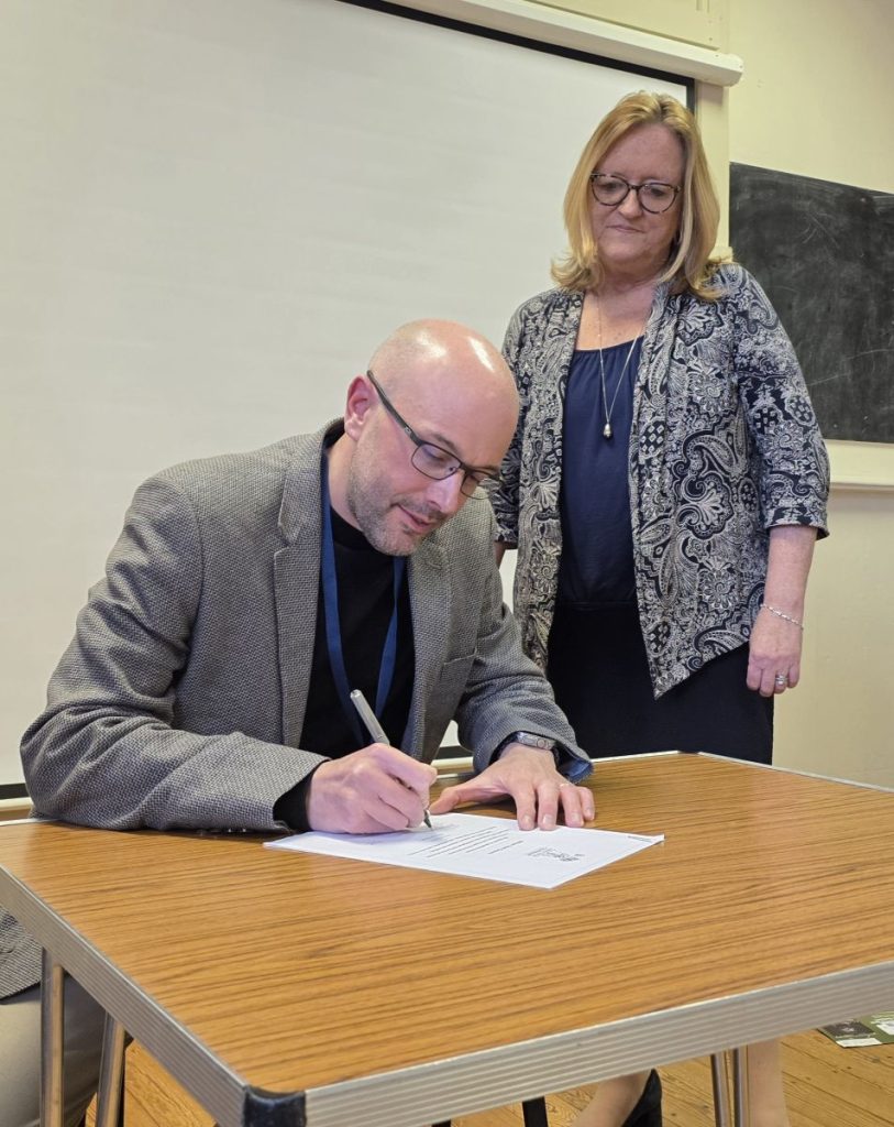 Mayor and Town Clerk signing the armed forces covenant